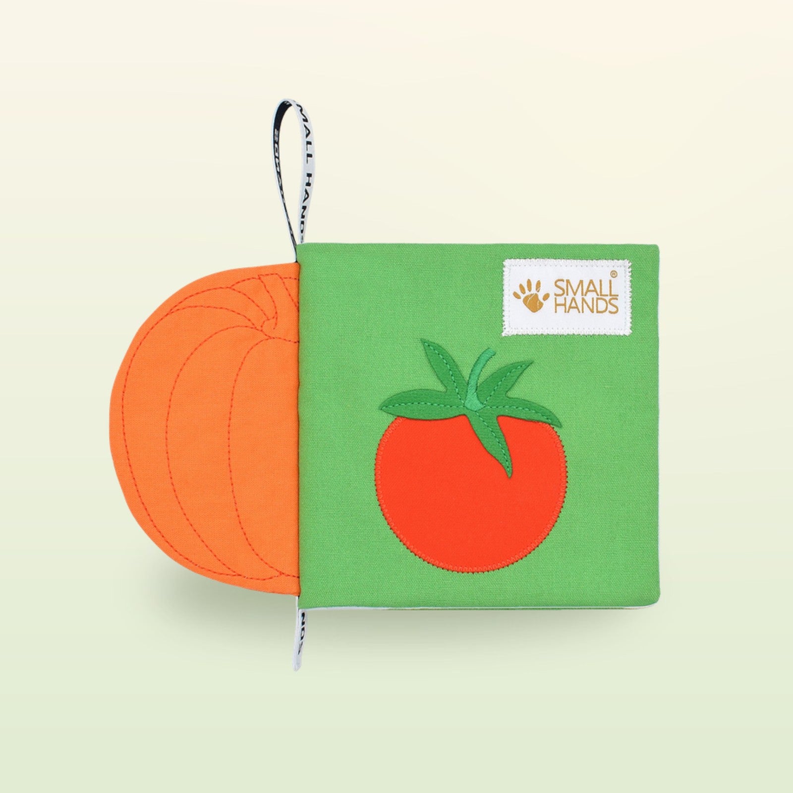 Small Hands Gemüse Montessori Stoffbuch Cover mit Tomate und Kürbis auf sanftem Wiesengrün-Hintergrund – ab 1 Jahr