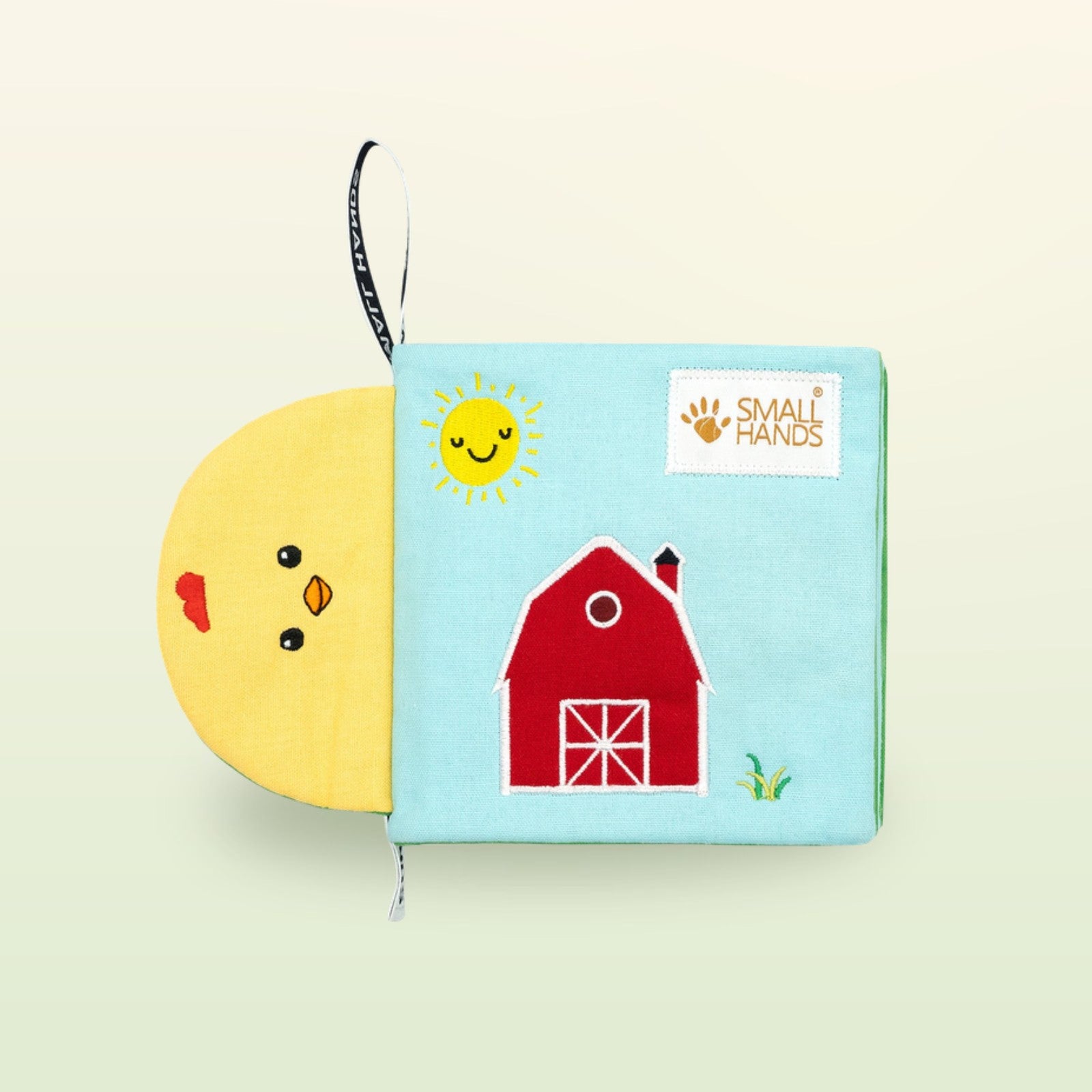 My First Book Small Hands Bauernhof Stoffbuch Cover mit Scheune und Sonne auf sanftem Wiesengrün-Hintergrund – ab 0 Monaten